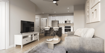 A modern living room with a grey sofa and a television.